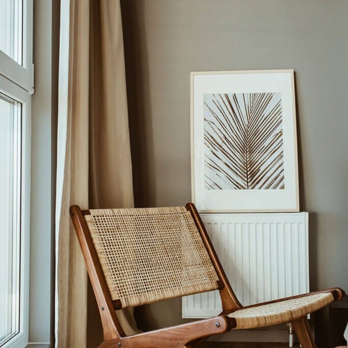 Inviting and calm counseling office space with a modern chair, suggesting a supportive environment for women's therapy.